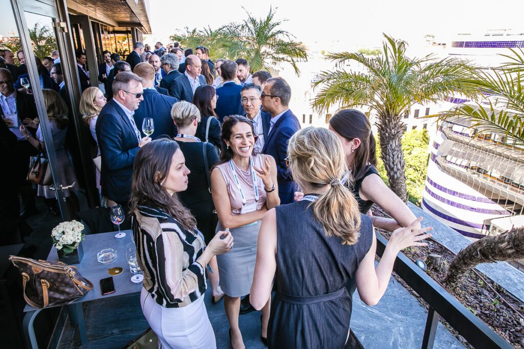 Group of people stand on an outside balcony