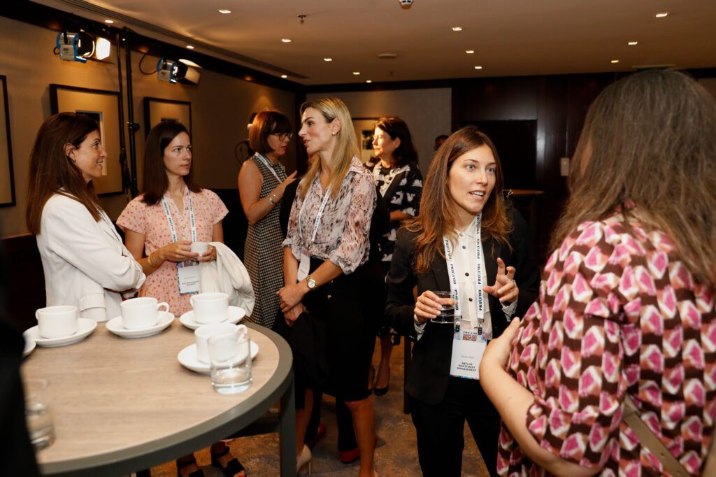 Women standing in groups having discussions
