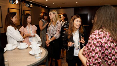 Women standing in groups having discussions