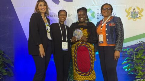 Four women standing in front of the clean cooking forum banner