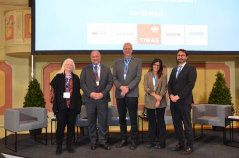 Speakers standing on stage