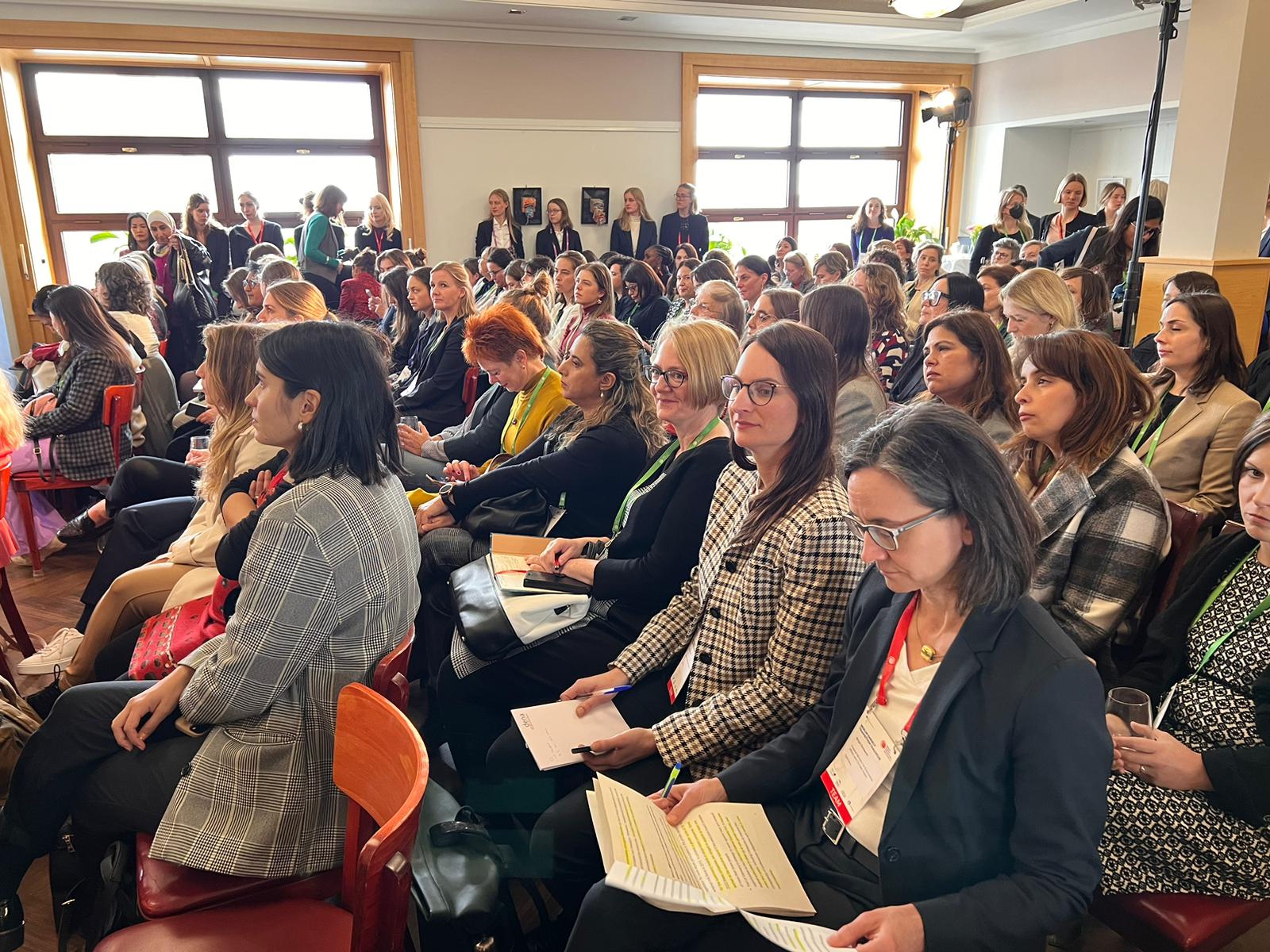 Image taken from the side of a full meeting room