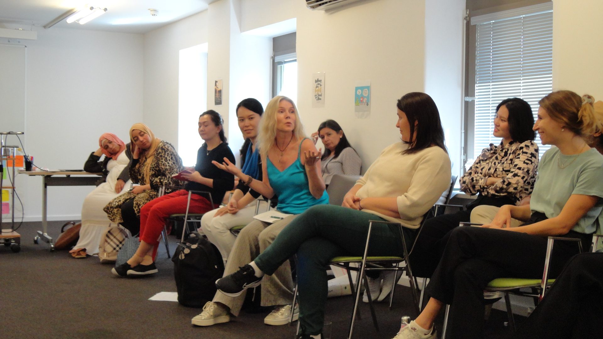 Woman speaking to a gathering of other seated women