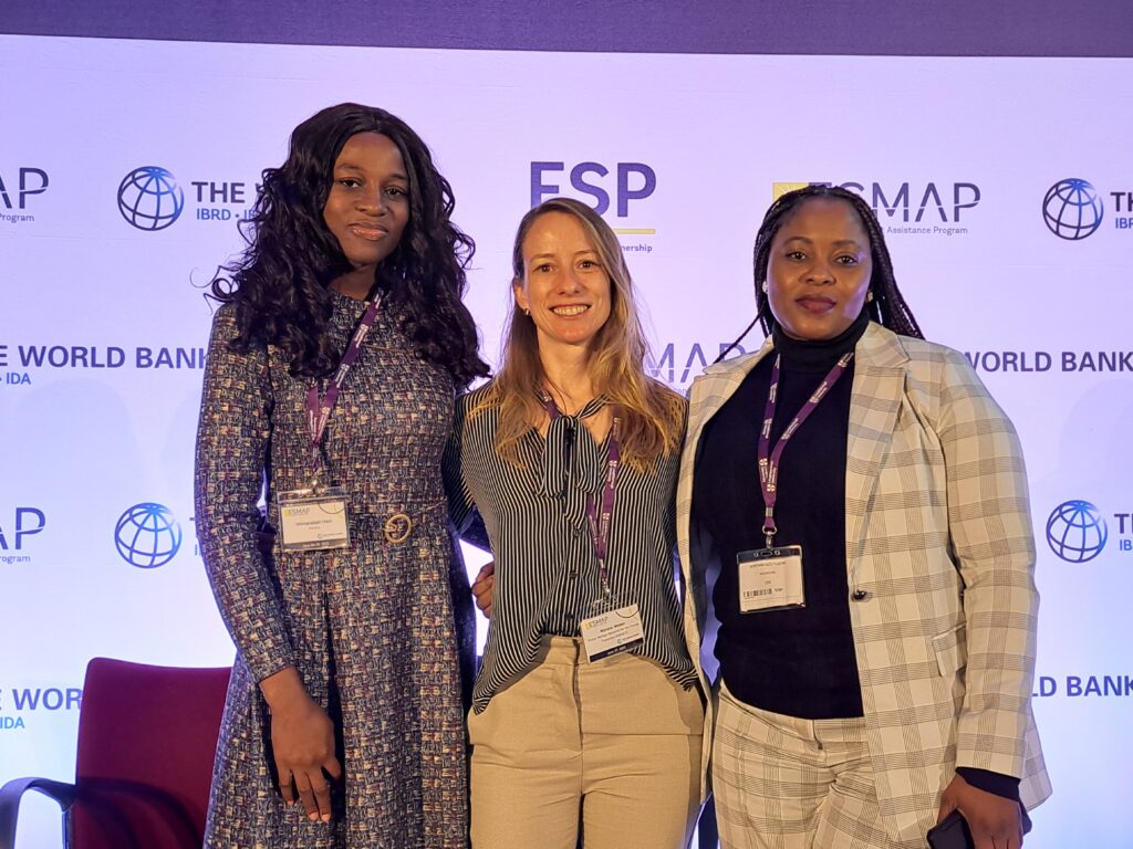 Three women standing on stage facing the camera